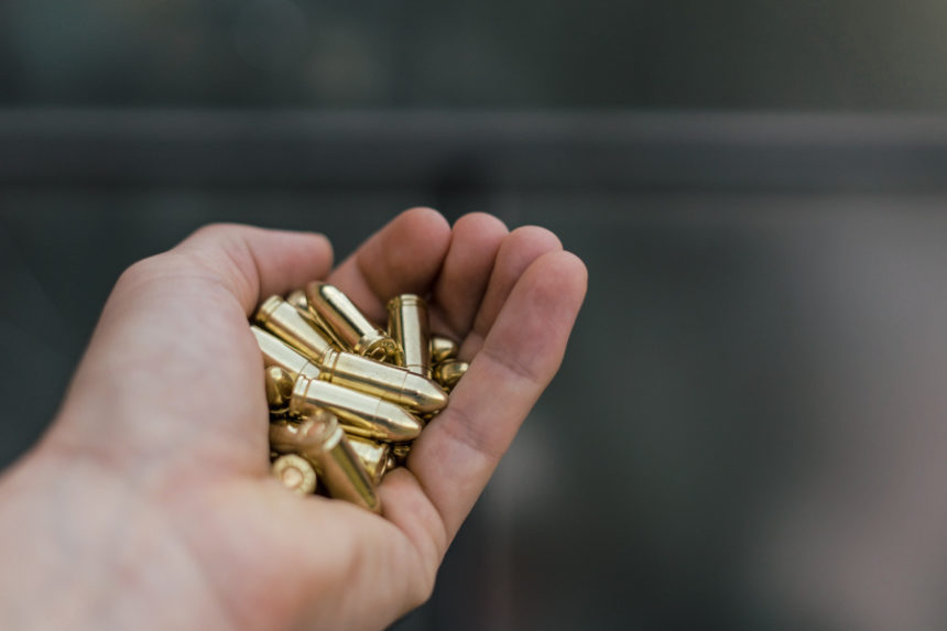 Close-up Of Hand Holding Bullets